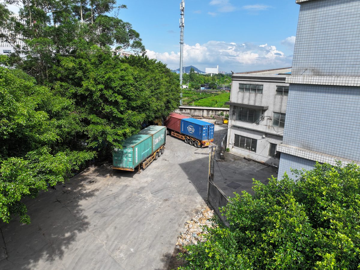Two ocean containers loading side by side at the factory
